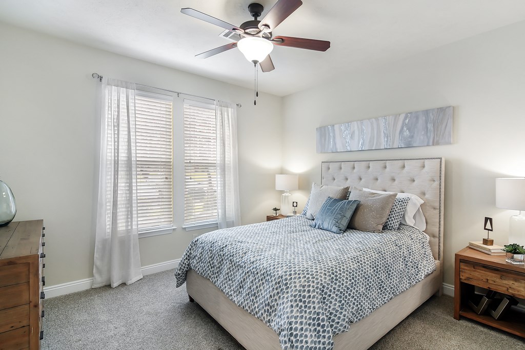 a bedroom with a bed and a ceiling fan at Charleston Apartment Homes, Mobile