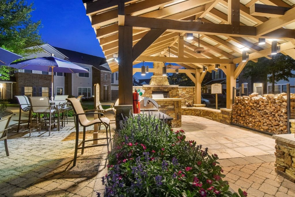 a patio with a fireplace and a pergola  at Kingston Crossing Apartment Homes, Bossier City, Louisiana