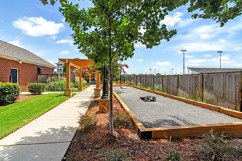 A shady area with a concrete slab and a tree in the middle at Summit of Shreveport Apartments, Shreveport, 71105