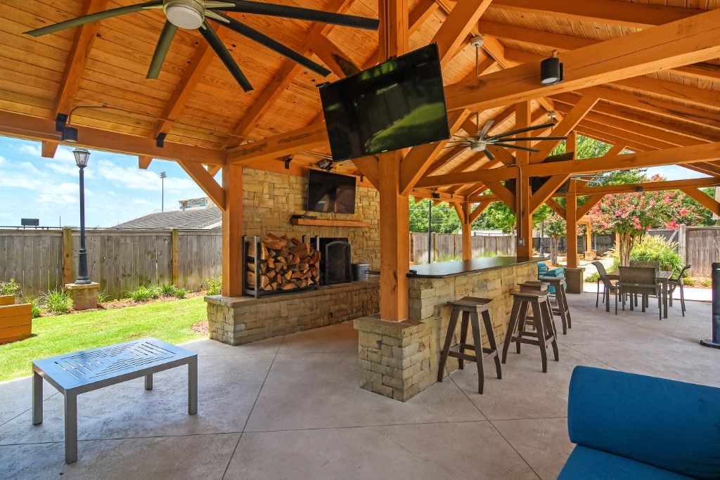 a patio with a fireplace and a tv at Summit of Shreveport Apartment Homes, Shreveport, Louisiana