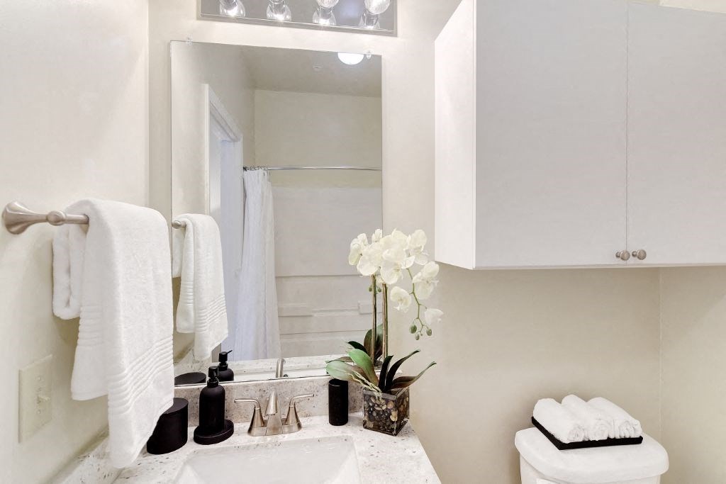 a bathroom with a sink and a mirror at Summit of Shreveport Apartment Homes, Shreveport, LA
