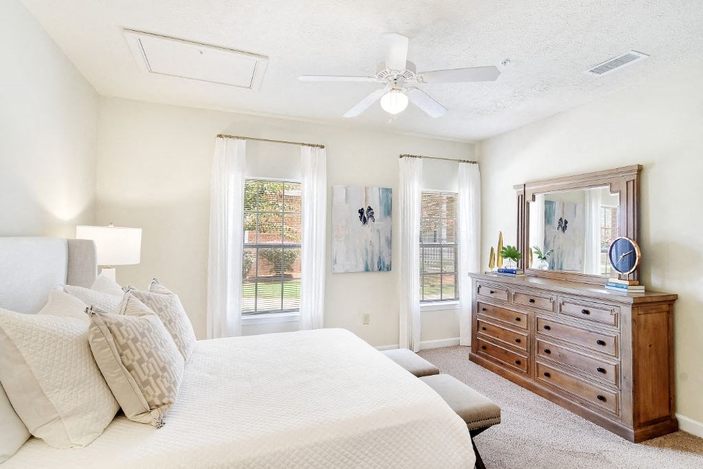 a bedroom with a large bed and a dresser at Summit of Shreveport Apartment Homes, Shreveport, 71105