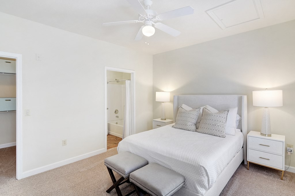 a bedroom with a large bed and a ceiling fan at Summit of Shreveport Apartments, Shreveport, Louisiana