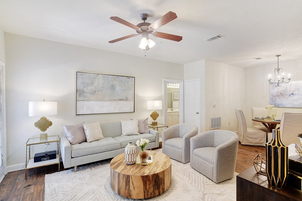 a living room with a couch and chairs and a ceiling fan at Summit of Shreveport Apartments, Shreveport, LA
