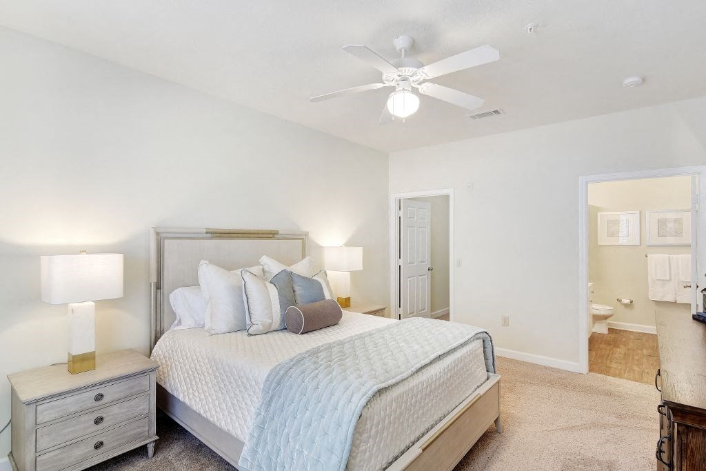a bedroom with a bed and a ceiling fan at Summit of Shreveport Apartment Homes, Shreveport