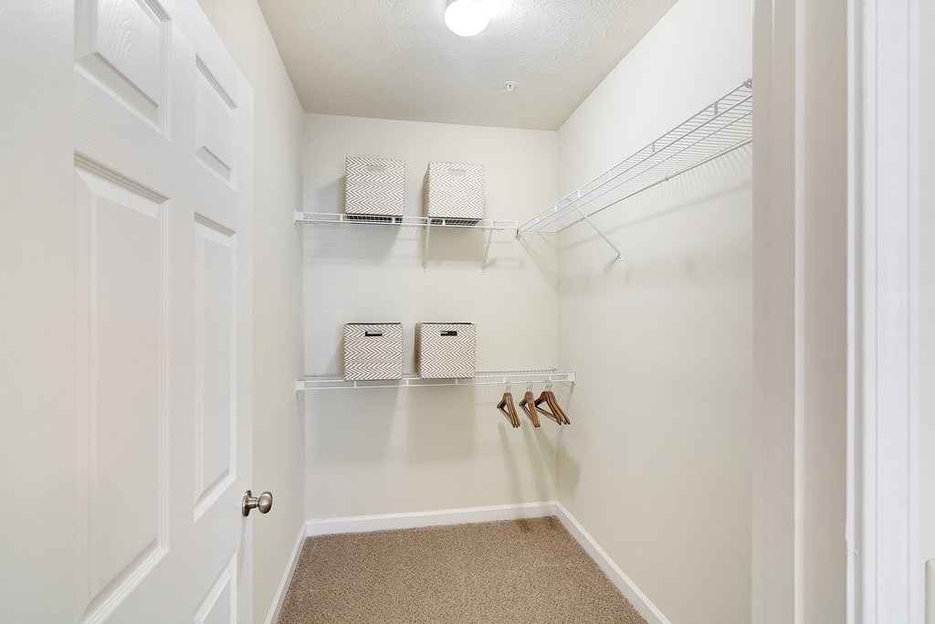 a walk in closet with shelves and shoes on the wall at Summit of Shreveport Apartments, Shreveport, LA, 71105