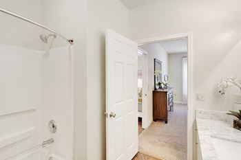 white bathroom with a walk in shower at Summit of Shreveport Apartments, Louisiana