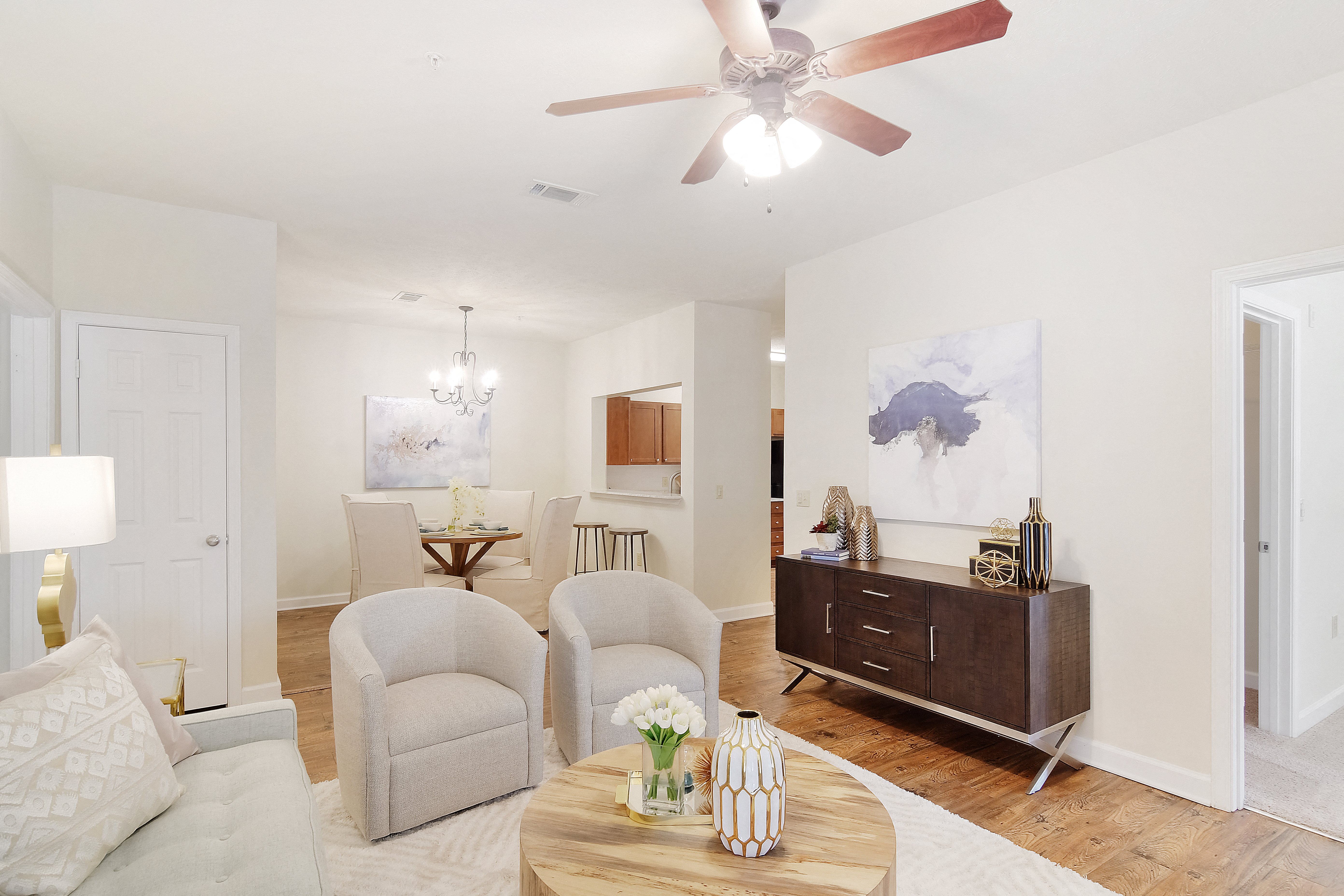 a living room with furniture and a ceiling fan