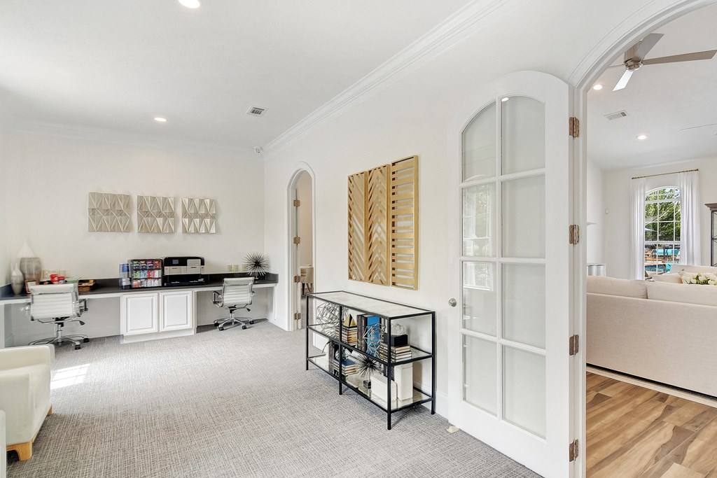 a living room with white walls and a glass door at Summit of Shreveport Apartments, Louisiana