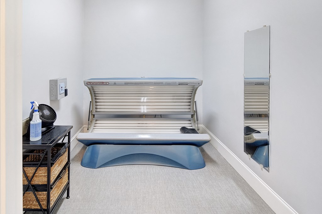 a patient room with a hospital bed and a mirror at Summit of Shreveport Apartments, Shreveport, Louisiana