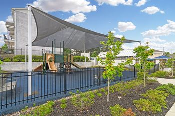 a pool with a canopy over it next to a building at Parkwest Apartment Homes, Hattiesburg