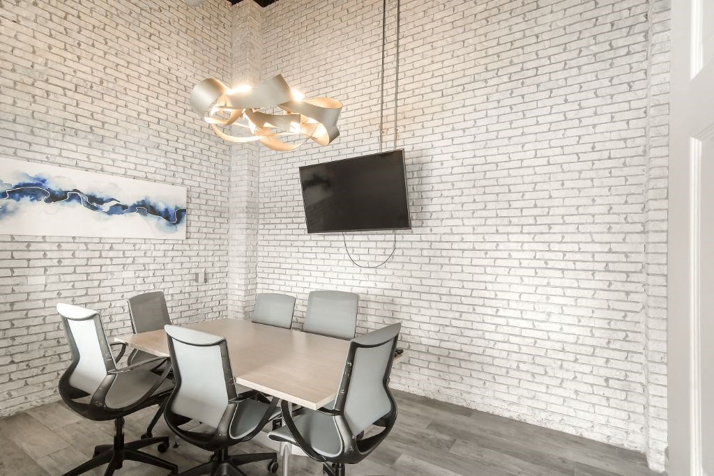 a conference room with a table and chairs and a tv on the wall  at Parkwest Apartment Homes, Mississippi, 39402
