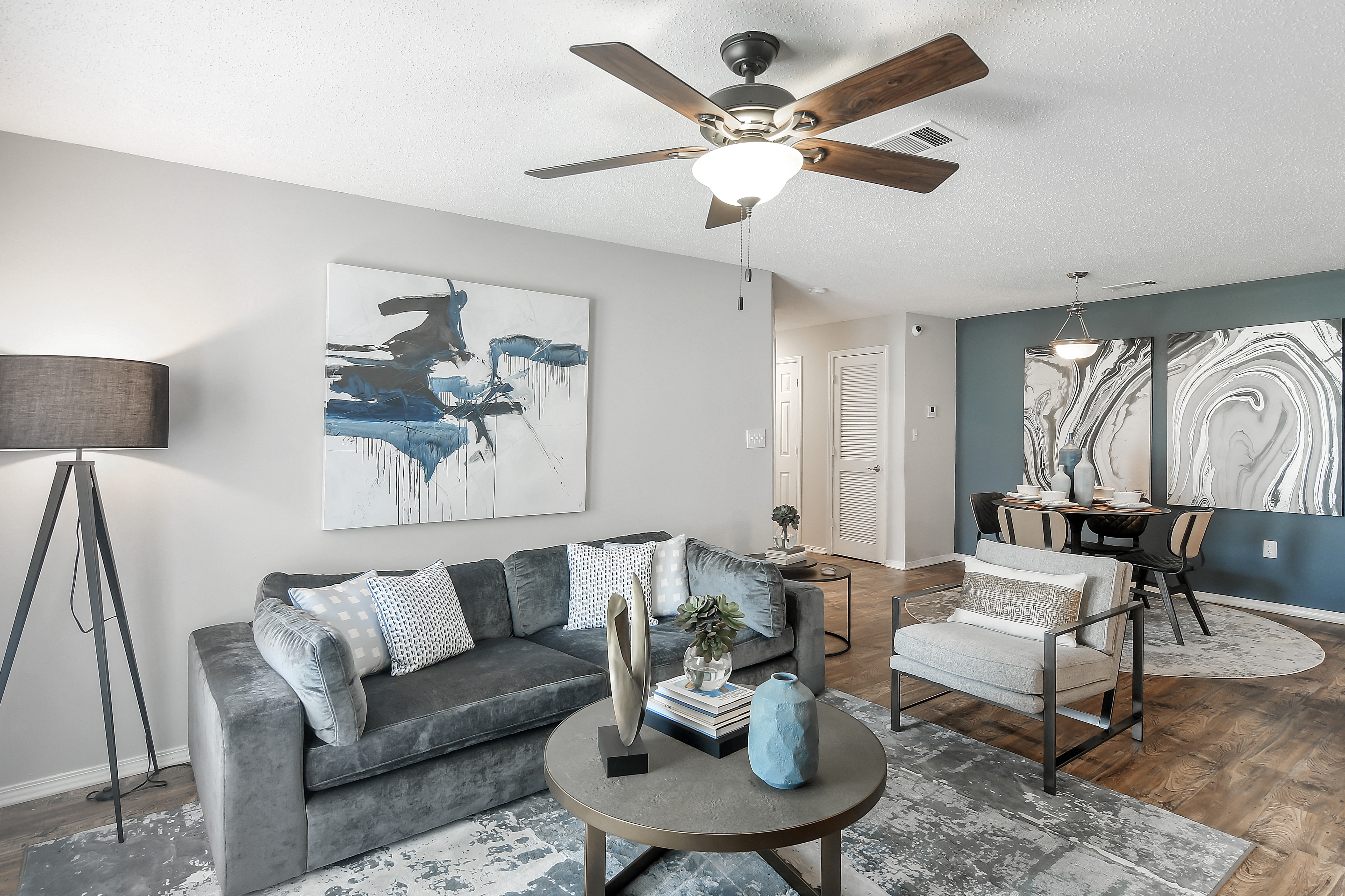 a living room with a ceiling fan and a couch
