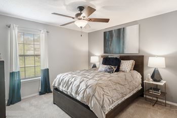 a bedroom with a bed and a ceiling fan at parkwest apartment homes in hattiesburg ms at Parkwest Apartment Homes, Hattiesburg, 39402