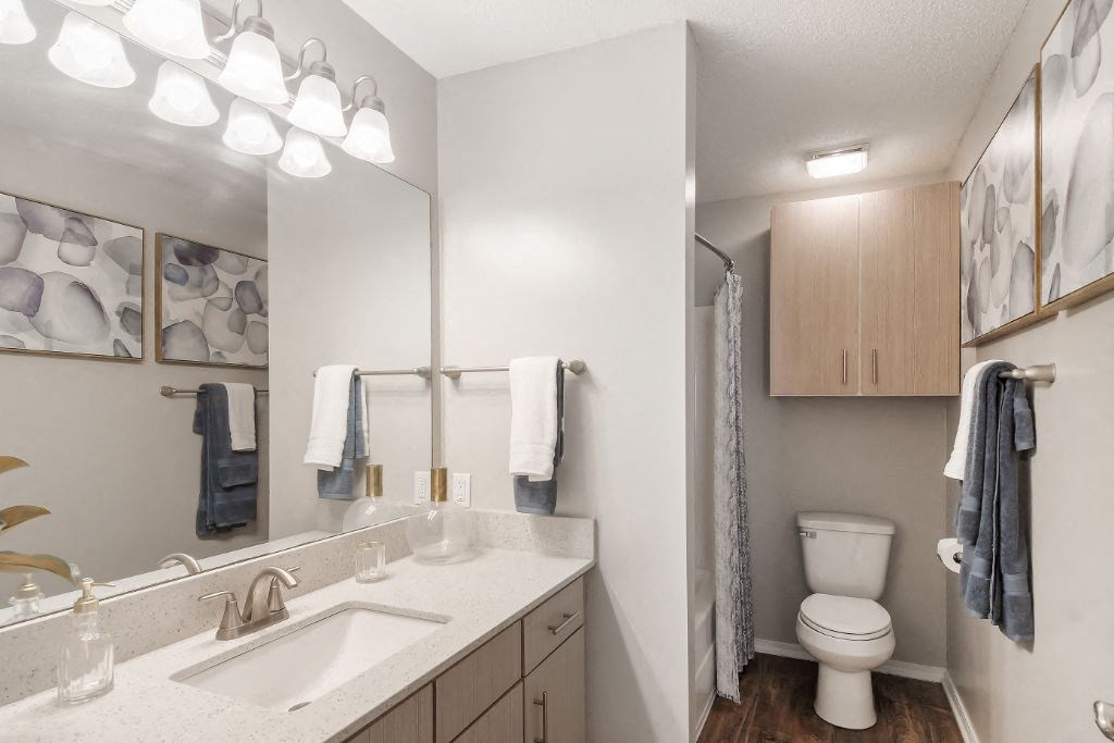 a bathroom with a sink toilet and shower  at Parkwest Apartment Homes, Hattiesburg, MS, 39402