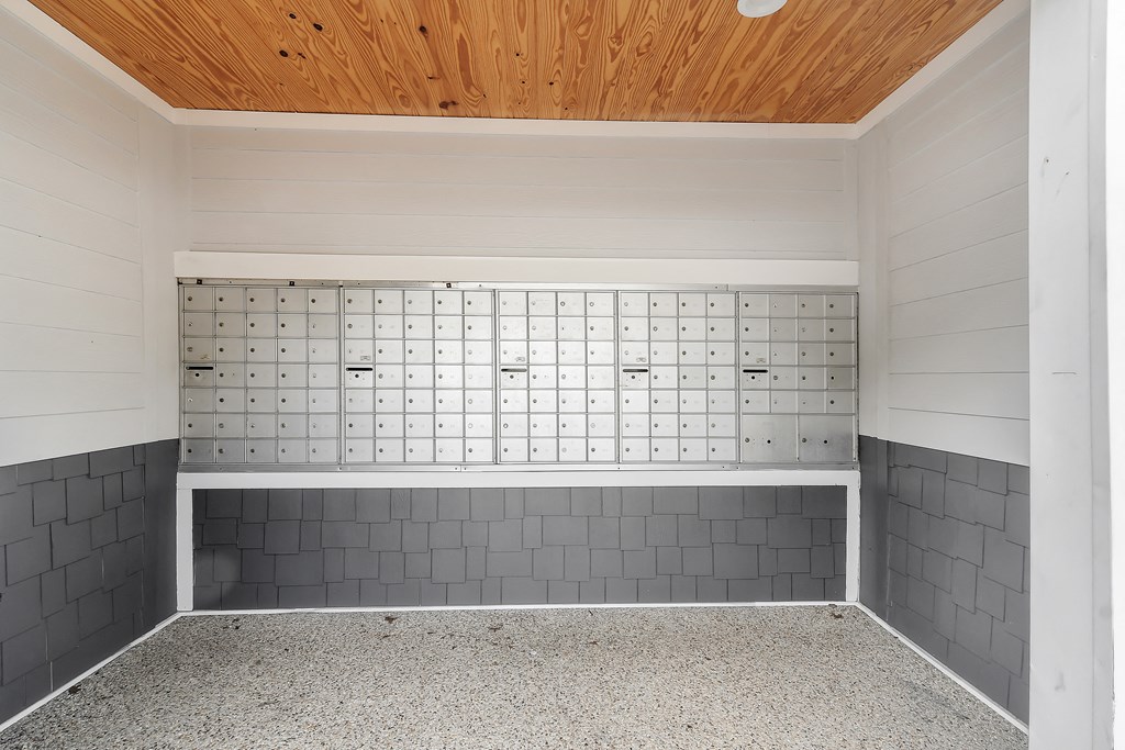an empty room with a tile wall and a wood ceiling at The Woodlands Apartment Homes, Meridian, 39301
