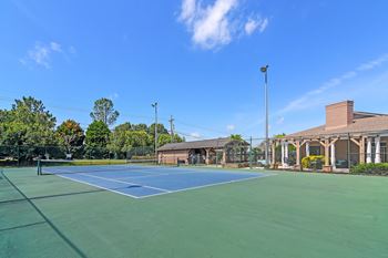 Tennis court with lounge area at Highpointe Apartment Homes, Brandon, MS, Mississippi  , 39042