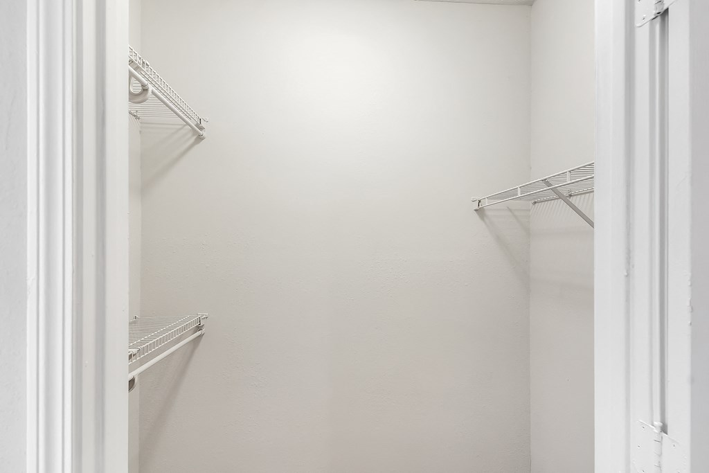 Walk in closet with two empty shelves at Highpointe Apartment Homes, Brandon
