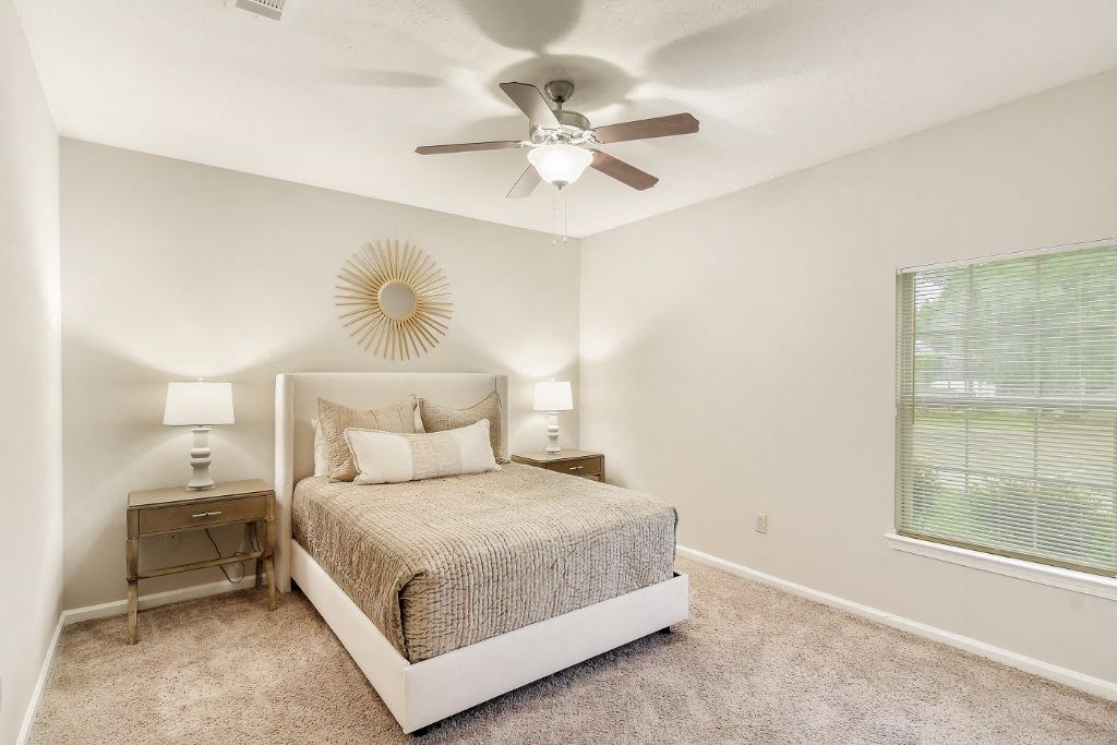 a bedroom with a bed and a ceiling fan  at Highpointe Apartment Homes, Mississippi, 39042