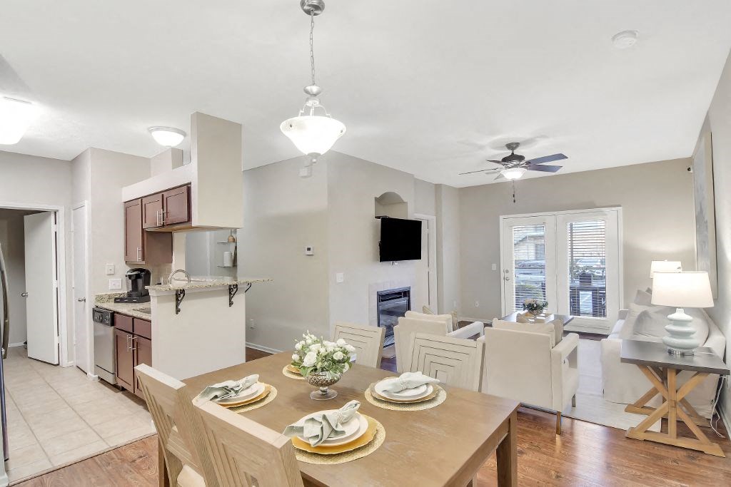 a dining room and living room with a table and chairs at Ashford Place Apartment Homes, Flowood, Mississippi