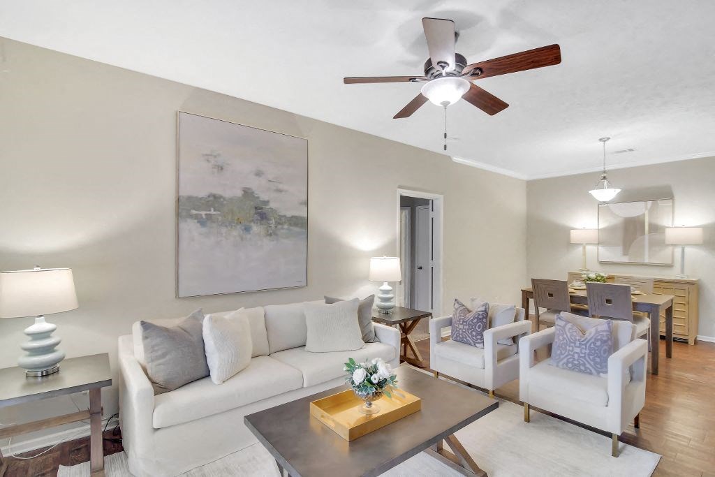 a living room with a couch and two chairs at Ashford Place Apartment Homes, Flowood
