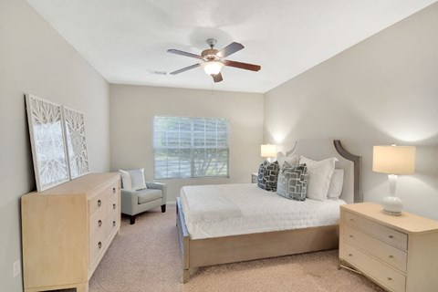 a bedroom with a bed and a ceiling fan at Ashford Place Apartment Homes, Flowood, 39232
