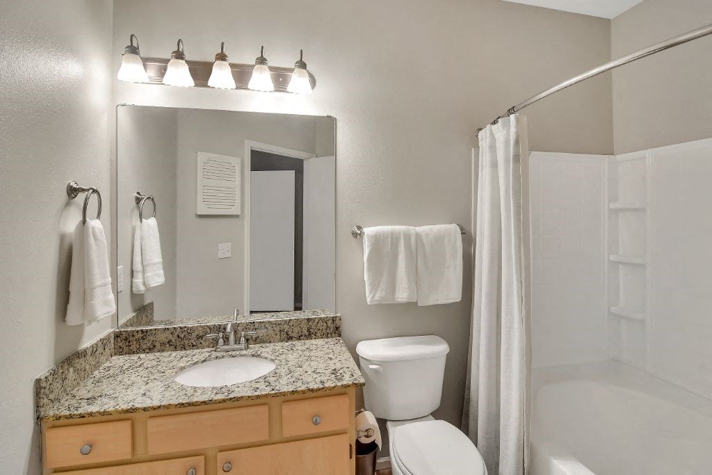 a bathroom with a sink toilet and shower at Ashford Place Apartment Homes, Flowood, MS, 39232