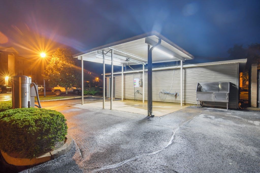 a gas station at night with a dark sky in the background at Ashford Place Apartment Homes, Flowood, MS