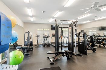 a fitness room with weights and other exercise equipment at Legacy Apartment Homes in Ridgeland, MS