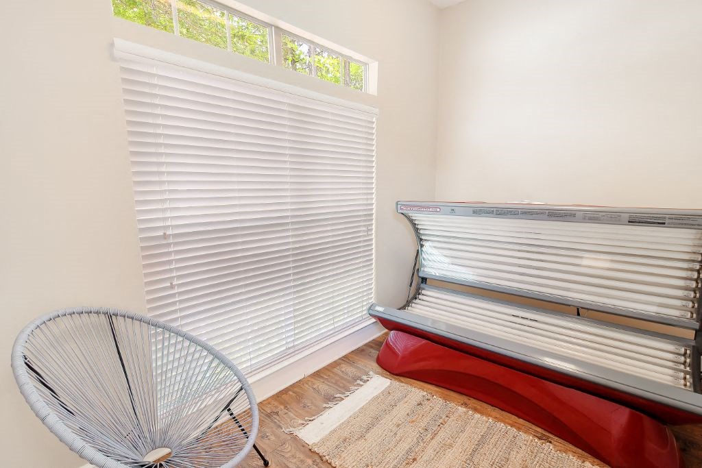 a room with a bench and a fan in front of a window  at Legacy Apartment Homes, Ridgeland, MS