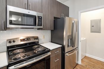 a kitchen with stainless steel appliances and a refrigerator at Legacy Apartment Homes in Ridgeland, MS