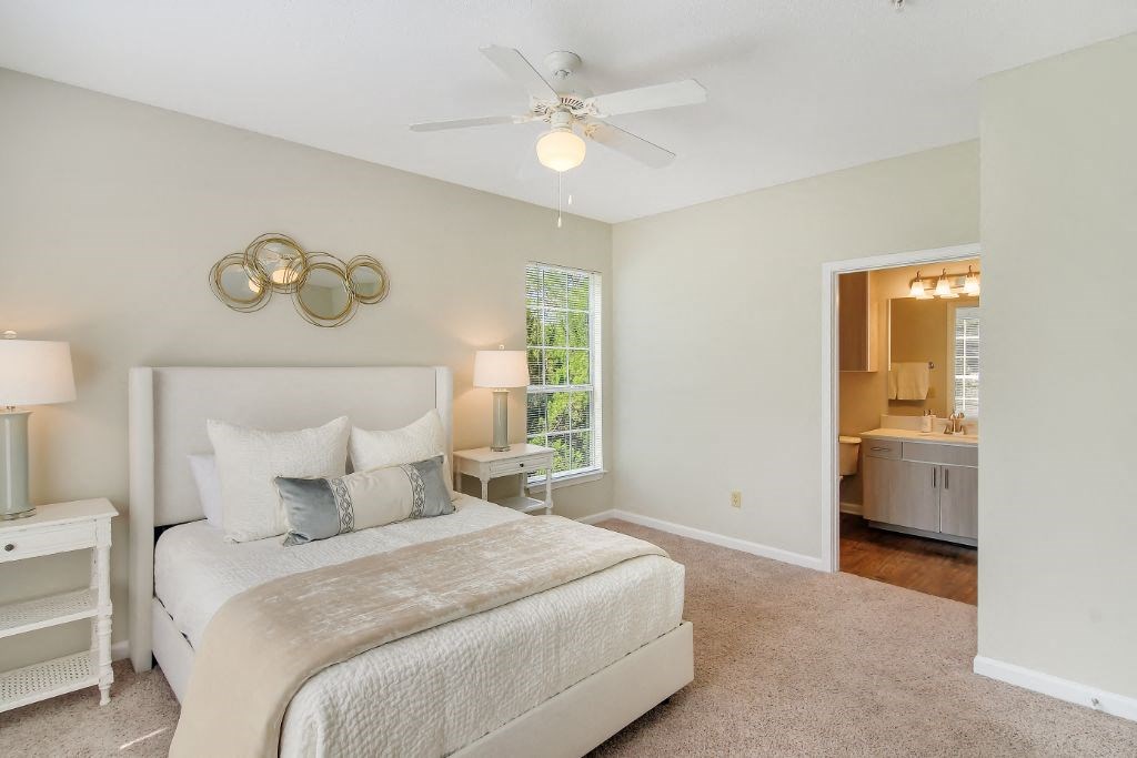 a bedroom with a bed and a ceiling fan  at Legacy Apartment Homes, Ridgeland, Mississippi