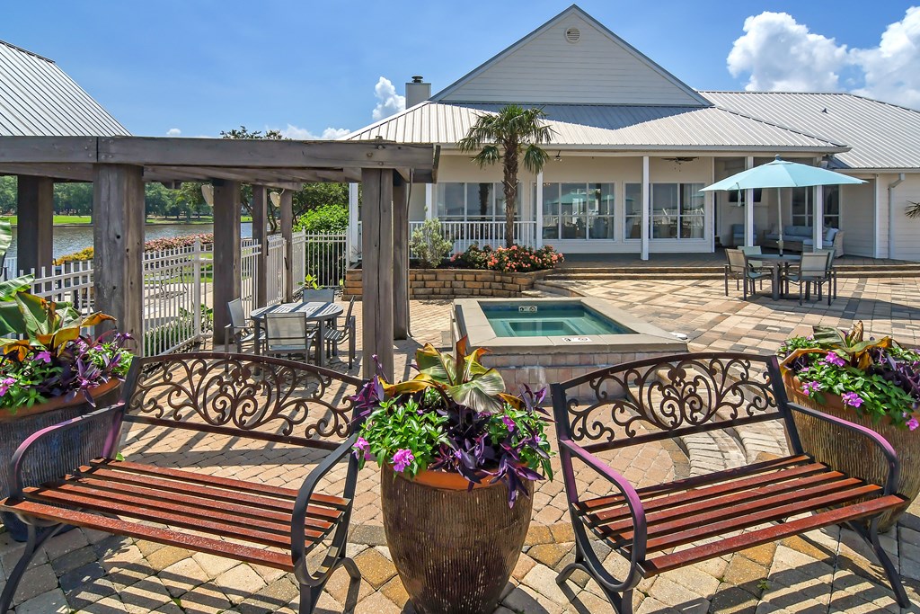 a patio with benches and a pool and a building at Lakeshore Pointe Apartment Homes, Brandon, 39047