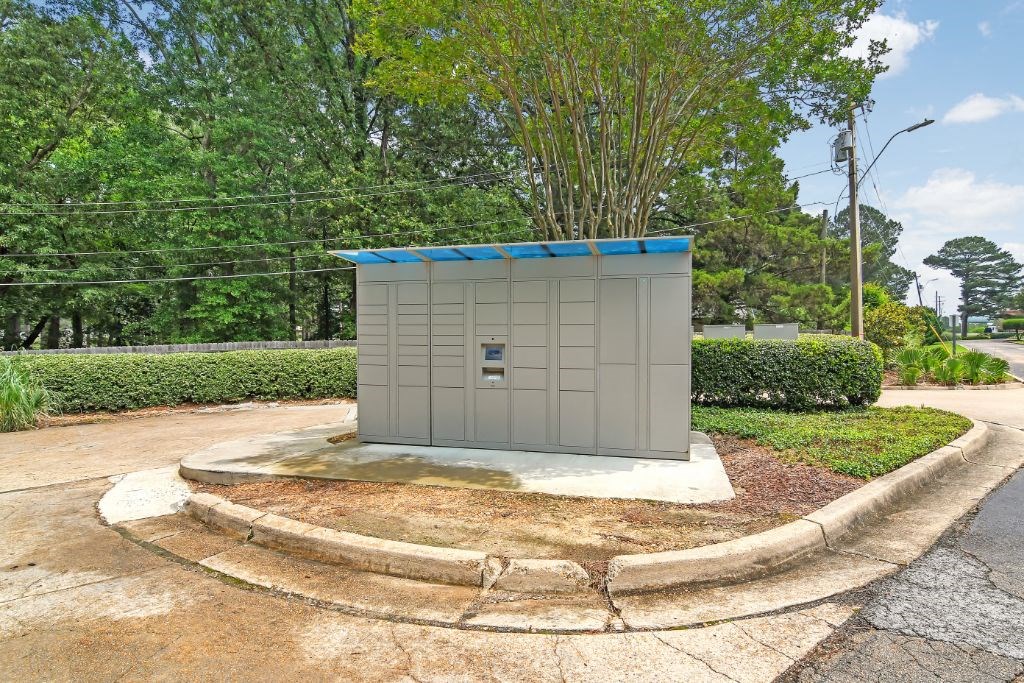 a small building with a blue roof on the corner of a street at Lakeshore Pointe Apartment Homes, Brandon, MS, 39047