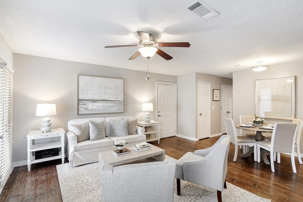 an open living room and dining room with white furniture and a ceiling fan at Lakeshore Pointe Apartment Homes, Brandon, MS, 39047