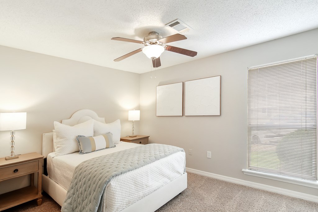 a bedroom with a bed and a ceiling fan at Lakeshore Pointe Apartment Homes, Mississippi, 39047