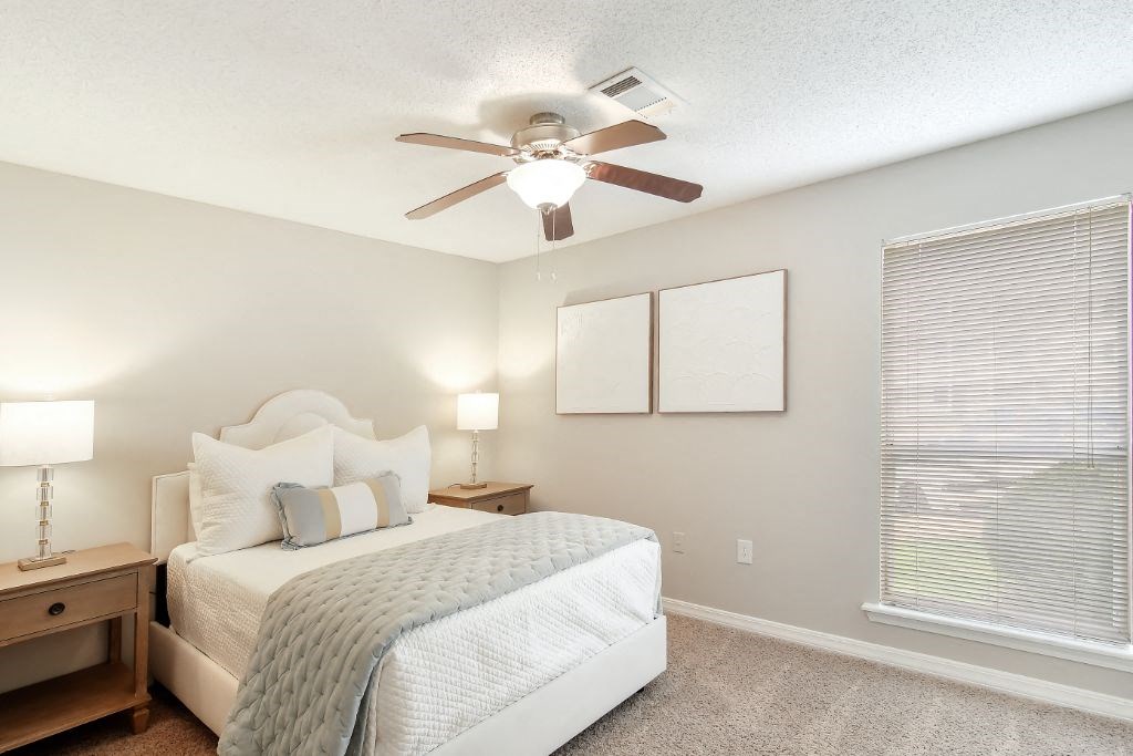 a bedroom with a large window and a ceiling fan at Lakeshore Pointe Apartment Homes, Brandon, MS, 39047