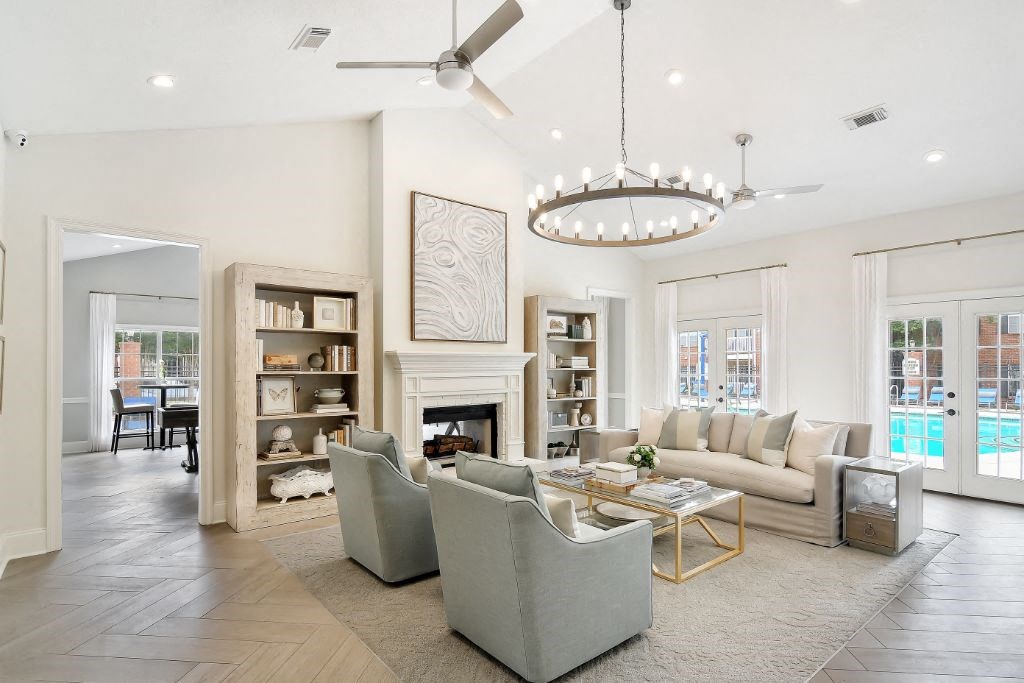 a living room with a fireplace and a chandelier  at Bridgewater Apartment Homes, Mississippi, 39047