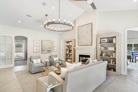a living room with couches and chairs and a fireplace at Bridgewater Apartment Homes, Brandon