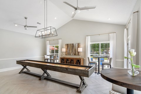 a living room with a pool table and a dining table at Bridgewater Apartment Homes, Brandon, MS 39047