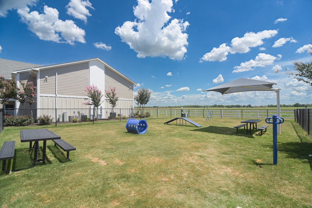 a picnic area with picnic tables and a building in the background at Reserve of Bossier City Apartment Homes in Bossier City, 71111