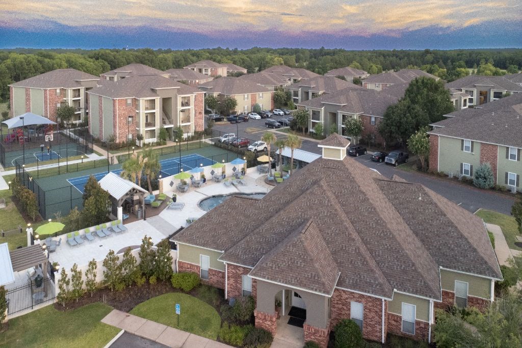 an aerial view of a pool and resort buildings at Canebrake Apartment Homes, Louisiana, 71115