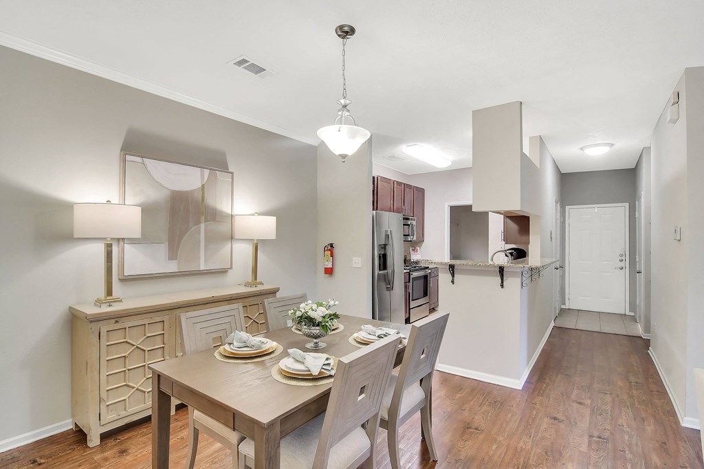 a kitchen and dining room with a table and chairs at Ashford Place Apartment Homes, Mississippi