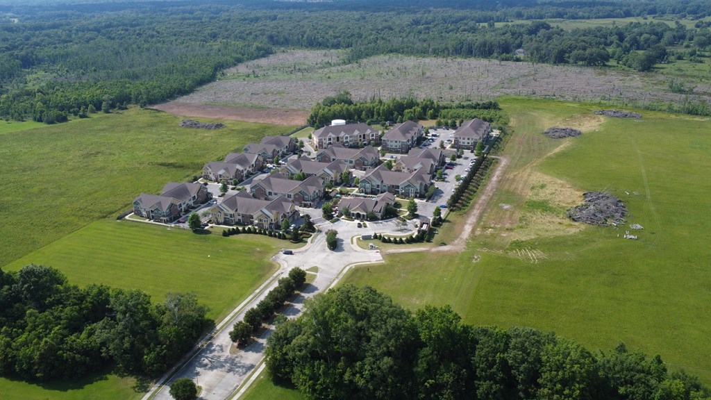 an aerial view of a neighborhood with houses and a field at Audubon Park Apartment Homes, Louisiana, 70791