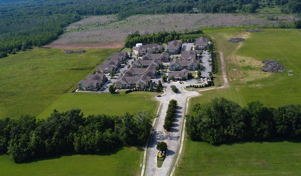 an aerial view of a neighborhood of houses in a field at Audubon Park Apartment Homes, Louisiana