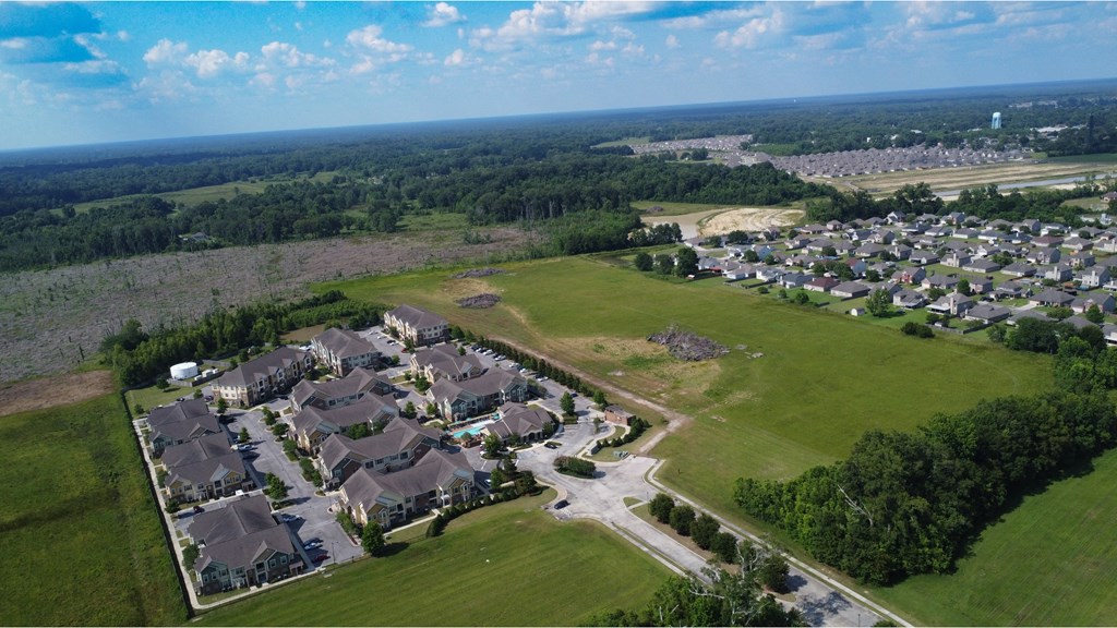 an aerial view of a neighborhood with houses and a field at Audubon Park Apartment Homes, Louisiana, 70791