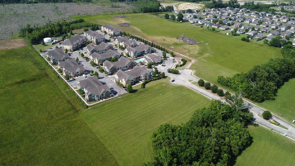an aerial view of a neighborhood with a field of green grass and houses on a at Audubon Park Apartment Homes, Louisiana