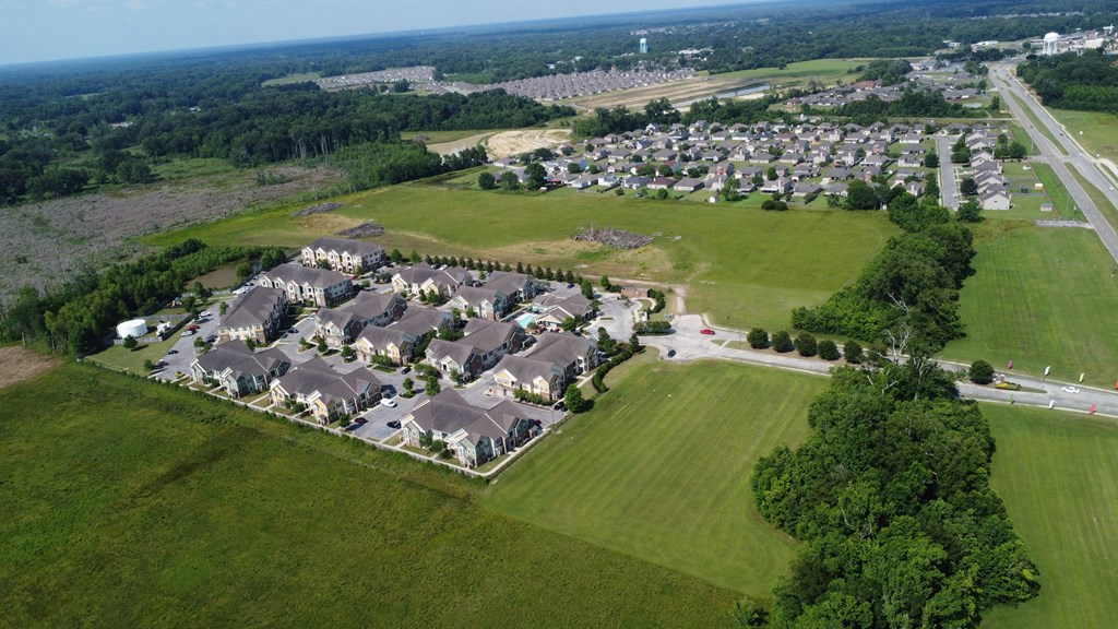 an aerial view of a neighborhood with houses and a field at Audubon Park Apartment Homes, LA