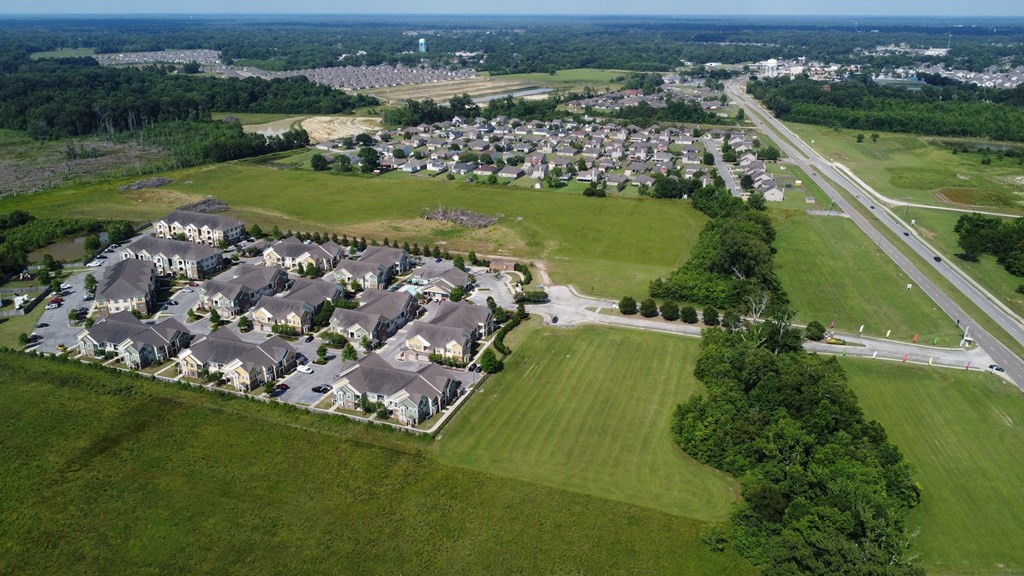 an aerial view of a neighborhood with houses and a field at Audubon Park Apartment Homes, LA