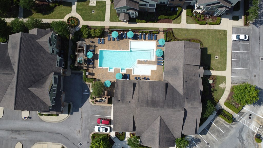 an aerial view of a neighborhood with a swimming pool in the middle of two houses at Audubon Park Apartment Homes, Louisiana